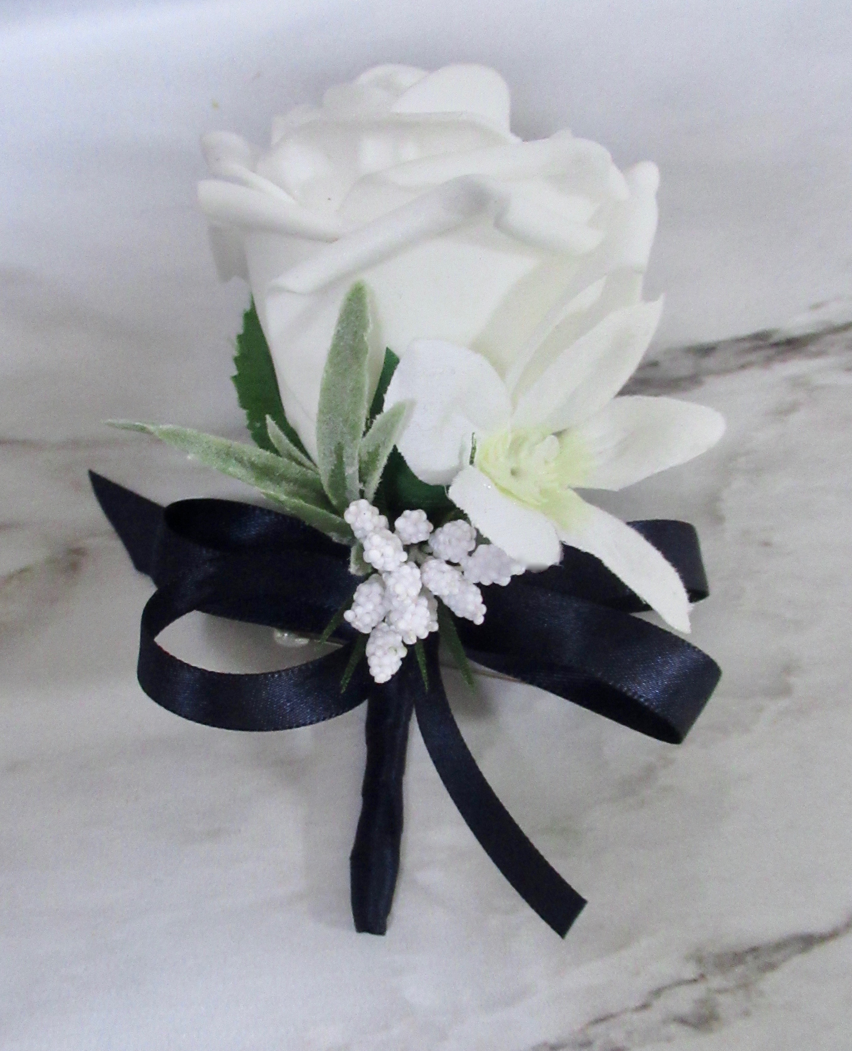 Navy blue and white buttonhole for wedding